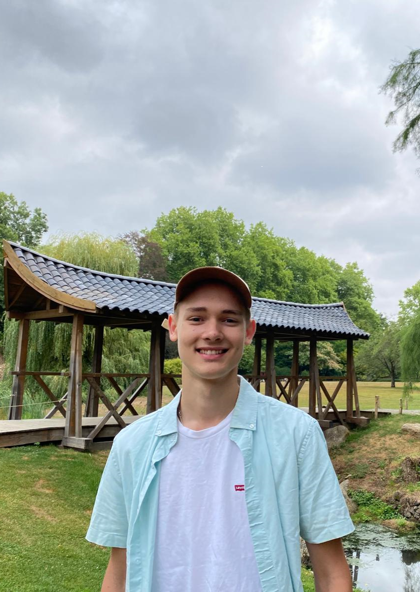 picture of me smiling outside with a japanese bridge in the background